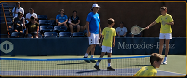 Tennis instruction session with ball kids